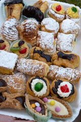 Italian sweet dessert dolce pastry and cakes with cream and fruits on plate made in artisanal bakery in Rome, Italy, close up