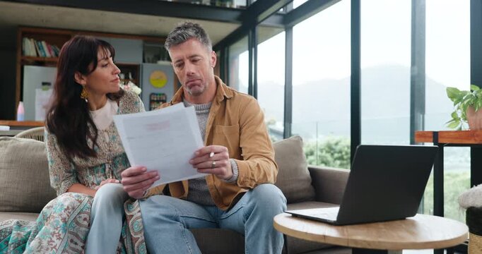 Paper, review or couple in home with laptop, signing will or trust agreement in marriage. Reading, mature man or woman on sofa with tech, discussion or postnuptial planning on legal document.