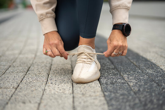 Person tying running shoe laces preparing for workout