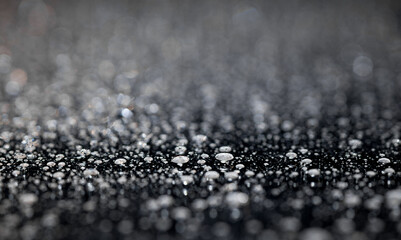 raindrops on a dark background.water drops on glass in close-up. Abstract dark background. Mockup for your logo. horizontal wallpaper or web banner.