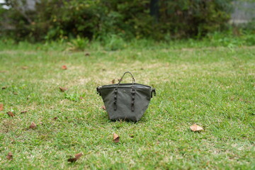 A small purse is sitting on the grass