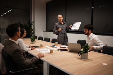 Medical professional presenting x-ray during business meeting