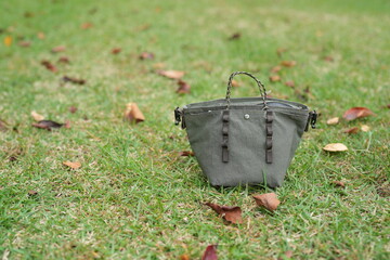 A small purse is sitting on the grass