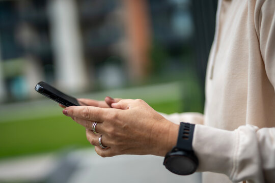 Person checking smartphone, connecting with digital device