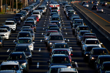 Drivers caught in a massive traffic jam on a multi-lane highway during daytime commute