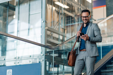 Business professional checking phone on staircase