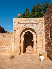 Ancient Islamic Archway with Zellige Mosaic Decoration Amidst Weathered Stone Walls at the Chellah Necropolis, Rabat, Morocco