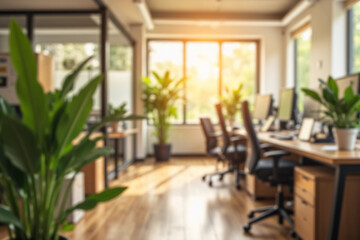 Blurred background of a modern office interior bathed in warm sunlight, highlighting the serene work environment with plants and organized desks for optimal productivity.