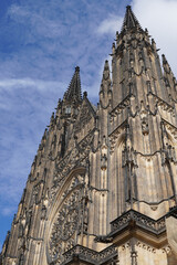 Fototapeta premium Beautiful aerial and detailed view of St. Vitus Cathedral in Prague Castle, Czech Republic, showcasing Gothic architecture, gargoyles, stained glass, and the historic city skyline.