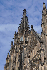 Fototapeta premium Beautiful aerial and detailed view of St. Vitus Cathedral in Prague Castle, Czech Republic, showcasing Gothic architecture, gargoyles, stained glass, and the historic city skyline.