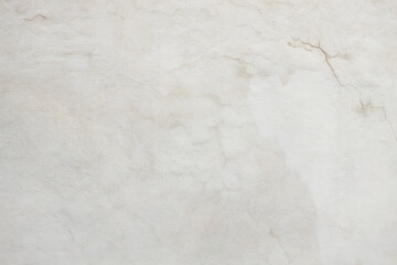 Textured white wall with subtle cracks and imperfections, showcasing a minimalist aesthetic, ideal for backgrounds and design projects with copy space