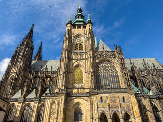 Fototapeta premium Beautiful aerial and detailed view of St. Vitus Cathedral in Prague Castle, Czech Republic, showcasing Gothic architecture, gargoyles, stained glass, and the historic city skyline.