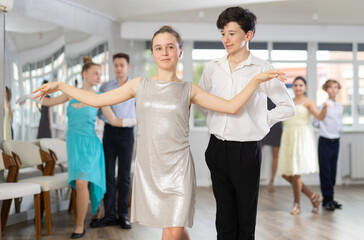 Fototapeta premium Pair dances - girls and guys in festive attire dance tango or samba