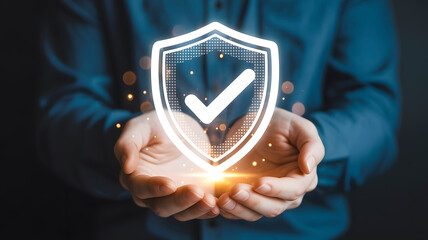 Hands gently cradle a glowing shield with a prominent checkmark, symbolizing trust, security, and protection in a modern digital world.