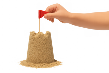 Child's hand placing red flag on sandcastle, representing dreams, goals, and childhood summer playtime