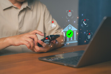 Man using smartphone and laptop with online banking icon, symbolizing digital finance, mobile...