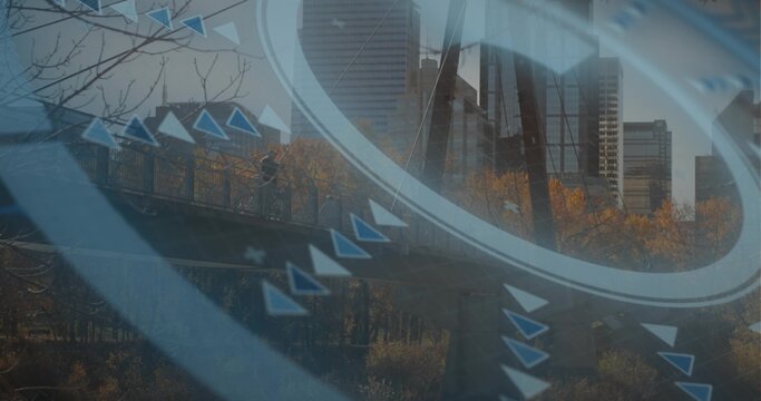 Walking silhouette crossing pedestrian bridge, with railing autumn trees and digital circles arrows