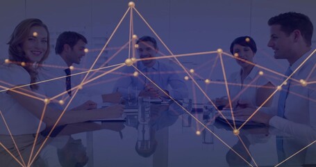 Colleagues discussing data around glass table in office, with notebooks, laptop and network overlay