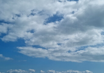 It's a sky with fluffy clouds and sunlight.