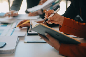 Business team working with new startup project plan and discussion information for financial strategy with laptop and digital tablet in a modern business lounge.