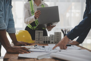 Construction and structure concept of Engineer or architect meeting for project working with partner and engineering tools on model building and blueprint in working site, contract for both companies.