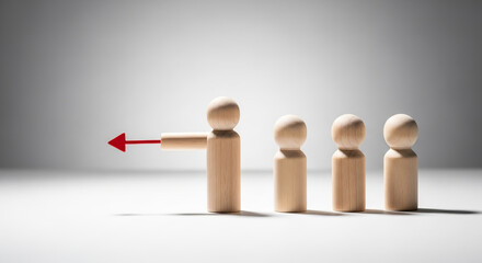 Wooden figure pointing a red arrow to the left, leading a line of other figures, representing leadership, direction, guidance, and setting a clear path or change in strategy.