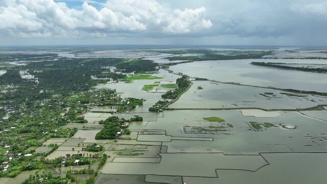 Drone shot of severe flooding, submerged homes, roads, and agricultural fields caused by collapse of river embankment due to strong tidal surge, Satkhira coastal region, Bangladesh