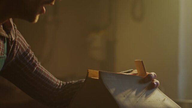 Crafting a custom bass guitar in a luthier workshop at dusk