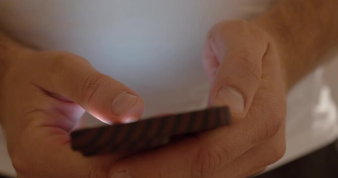 Close-up of a man&rsquo;s hands scrolling endlessly through TikTok or Reels. Concept of social media addiction, AI content, and short-attention culture.