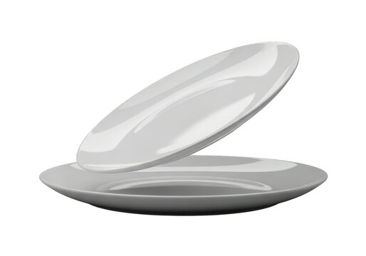 Two clean white oval ceramic plates stacked and tilted on a transparent background isolated on transparent background