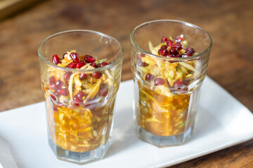 Traditional Indonesian fruit salad rujak serut in glass with spicy palm sugar dressing and pomegranate