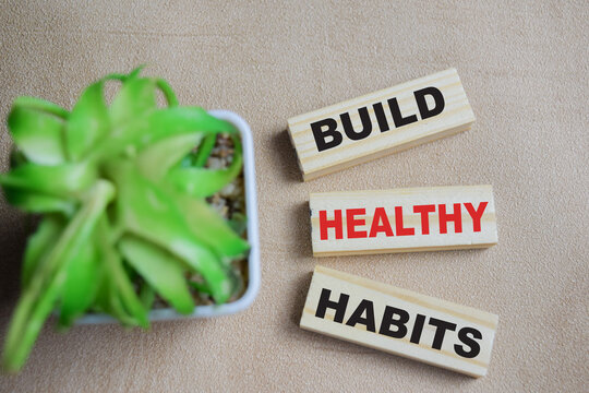 Build healthy habits on stacked wooden cubes on the table. Business and finance concept