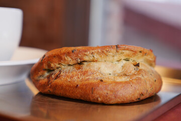 Freshly baked bread on a wooden table at a cafe
