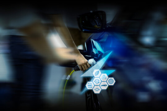 Power cable pump plug in charging power to electric vehicle EV car. - Powered by Adobe