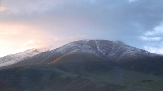 Sunrise time lapse of snowed hill in mongolia's altai mountain range