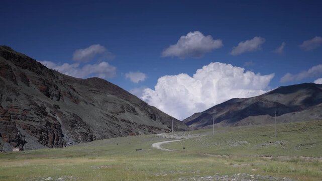 Time lapse of clouds forming and rolling across a mountain pass in mongolia's altai mountain region