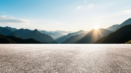 Under a cloudy sky, the wide asphalt road and the distant mountains set against the backdrop