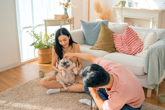 Asian family stay at home together with dog on holiday. Love couple lifestyle.