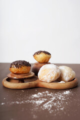 The donut rests neatly on a wooden plate over a warm brown surface