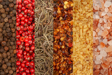 Top view of black pepper, pink pepper, thyme, chili, fried garlic, and pink salt