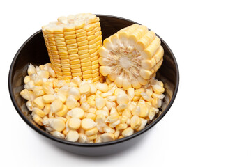 Black bowl with corn pieces and loose kernels