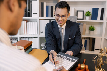 A professional lawyer discussing legal matters with a client in an office, providing legal advice and document review services, symbolizing justice, trust, and professional consultation.