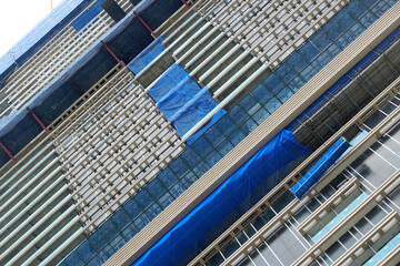 Naklejka premium Blue slanding net is used to cover the electric train base structure, used for temporary wall around construction site, fence prevents dust from construction site.