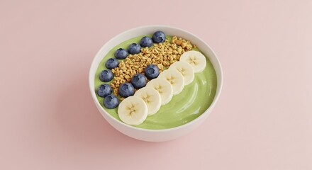 Top view of a vibrant green smoothie bowl beautifully arranged with fresh banana slices, blueberries, and granola on a pink background. A perfect concept for a healthy breakfast or snack