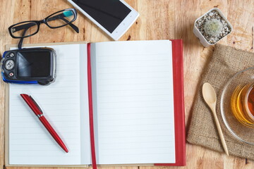 Aerial view (Design Mockup, poster) of a desk with an open notebook/diary in the center, ideal for displaying text or illustrations.
