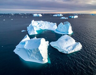Aerial view of majestic icebergs floating on the ocean, serene, and cold