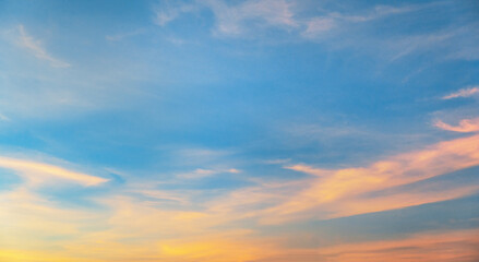 beautiful blue sky with  few clouds and  pinkish hue