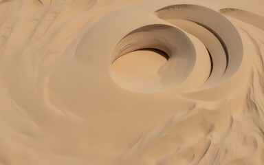 Obraz premium Swirling sand dunes with smooth curves and deep shadows in a desert landscape image