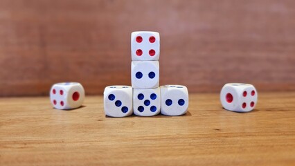 White dice stacked in random formation on blurred background.