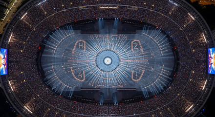 Obraz premium Spectacular Aerial View of a Mass Gathering in a Glowing Stadium